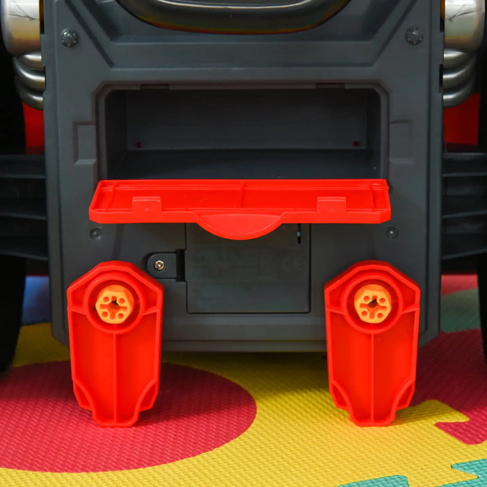 Close-up of kids' red and gray toy vehicle maintenance workshop set on colorful mat