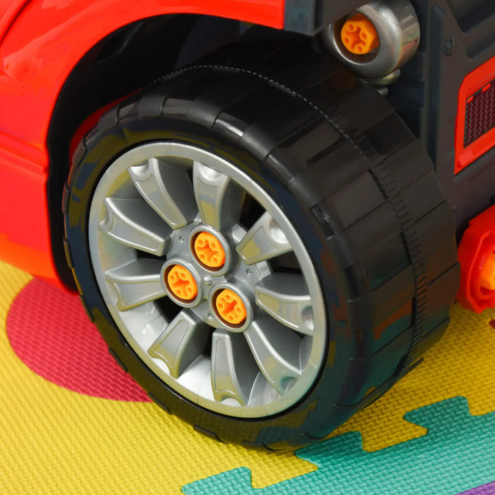 Close-up of toy car wheel from red kids engine toy set on colorful play mat