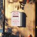 White Letters to Santa mailbox with red lettering on textured wall near Christmas stocking