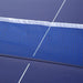 Close-up of blue table tennis table with blue net and white lines, split design