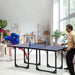 Two people playing table tennis on a blue 6ft professional table indoors