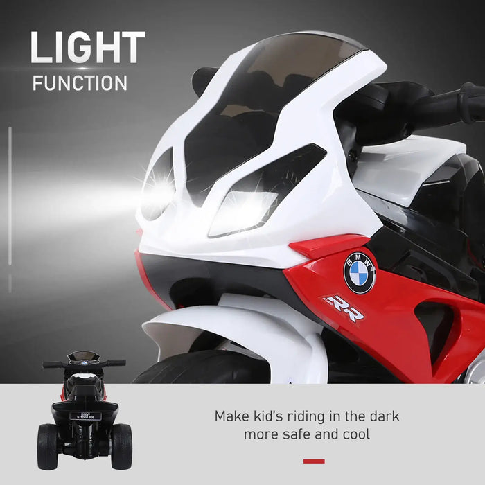 Close-up of white and red kids electric BMW S 1000 RR toy bike with front light function on