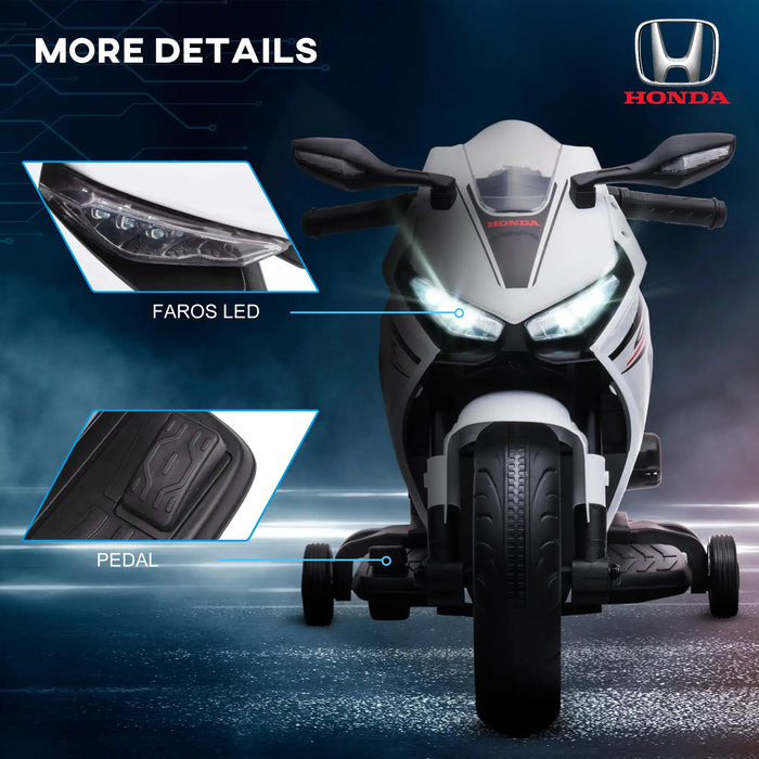 Child with a Honda licensed toy motorcycle on a dark background