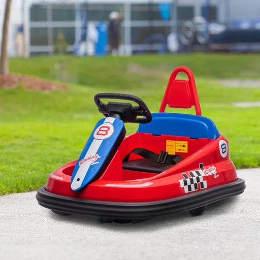 Red kids bumper car with racing decals, seatbelt, and steering wheel outdoors on grass