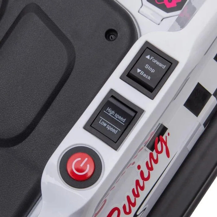 Close-up of white kids bumper car control panel with speed, direction buttons, and power switch