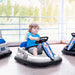 Child riding white 6V kids bumper car with steering wheel indoors, blue details, racing theme.