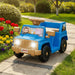 Blue and tan kids ride-on toy jeep with cartoon animal stickers, parked on garden path with flowers