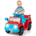 Toddler boy riding red and blue toy jeep with animal decals and working headlights