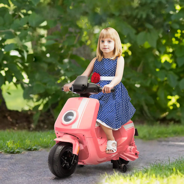 Young girl riding a pink toy scooter outdoors with greenery in the background