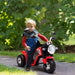 Child playing with a red toy motorcycle outdoors
