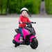 Child riding pink electric kids motorbike with training wheels outdoors