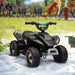 Black 6V kids electric quad bike on sand outdoors near playground equipment
