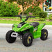 Green kids electric quad bike with black wheels parked outdoors on pavement