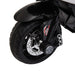 Close-up of front wheel on kids electric ride-on motorbike, black with shiny disc brake