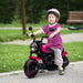Child riding pink 6V electric ride-on motorbike with training wheels outdoors