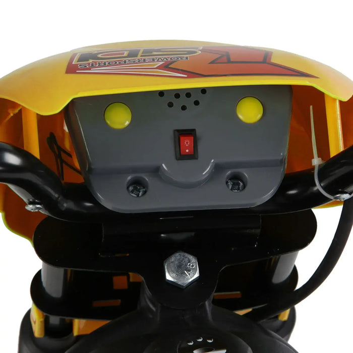 Close-up of yellow kids' electric ride-on motorbike handlebar with headlight switch