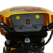 Close-up of yellow kids' electric ride-on motorbike handlebar with headlight switch