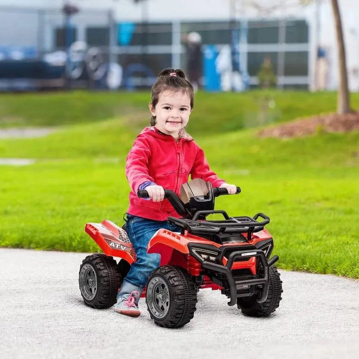 Child riding a red 6V electric ride-on quad ATV bike outdoors with racing stickers