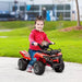 Child riding a red 6V electric ride-on quad ATV bike outdoors with racing stickers
