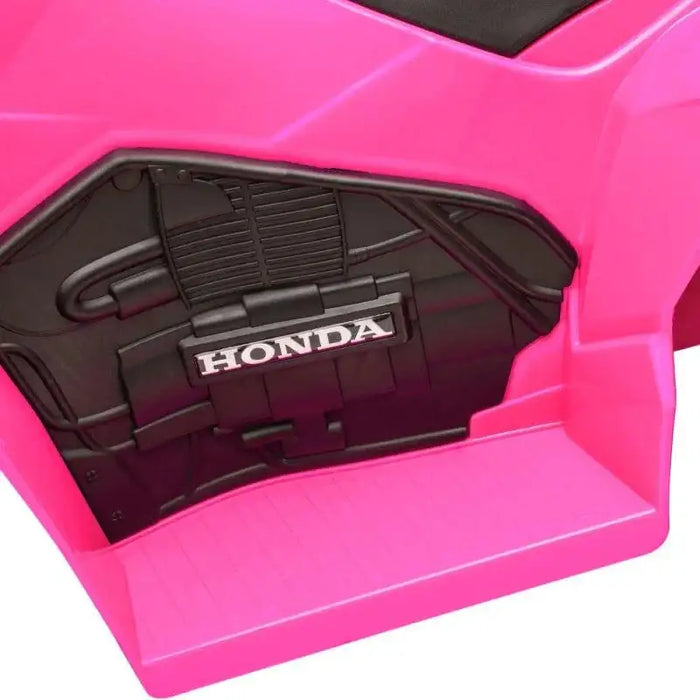 Close-up of pink kids Honda ride-on quad bike side panel with logo