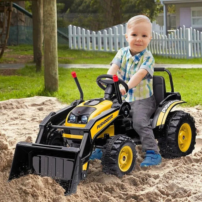 Child riding yellow 6V kids ride-on bulldozer toy with working shovel in sandbox