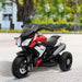 Children's toy motorcycle with red and black accents on a paved surface.