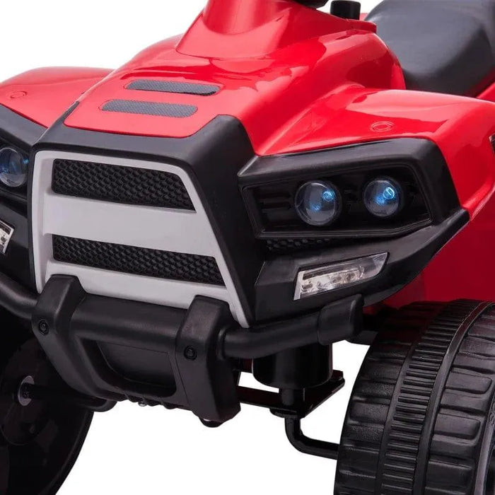 Red kids ride-on quad ATV bike with headlights and rugged wheels close-up