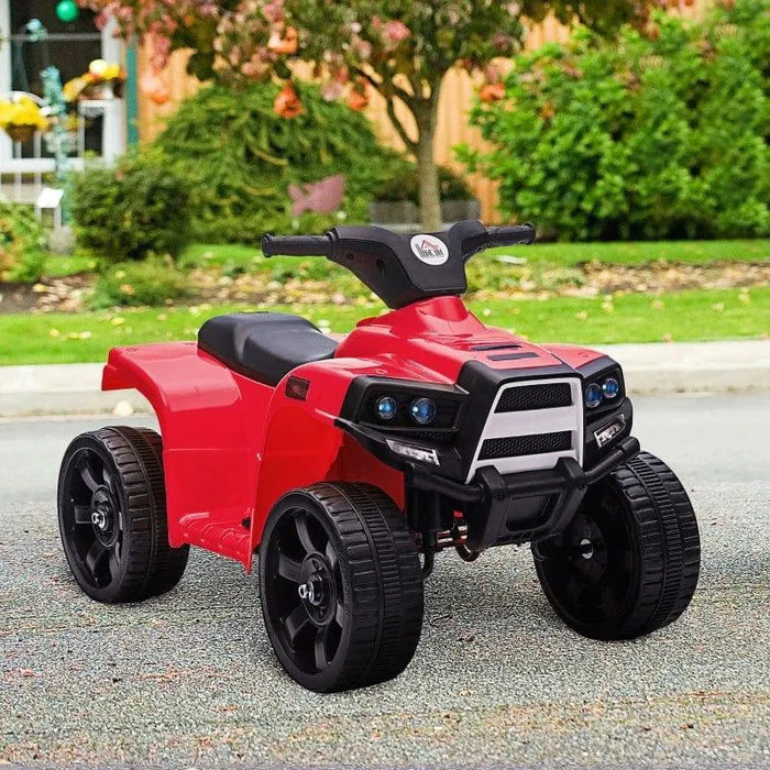 Red kids' ride-on quad ATV bike with lights and sounds parked outdoors on pavement