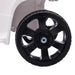 Close-up of black plastic ATV wheel on white 6V kids ride-on quad bike
