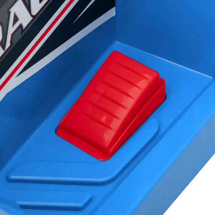 Close-up of red foot pedal on blue kids ride-on quad bike