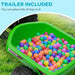 Green kids ride-on quad bike trailer filled with colorful plastic balls on grass
