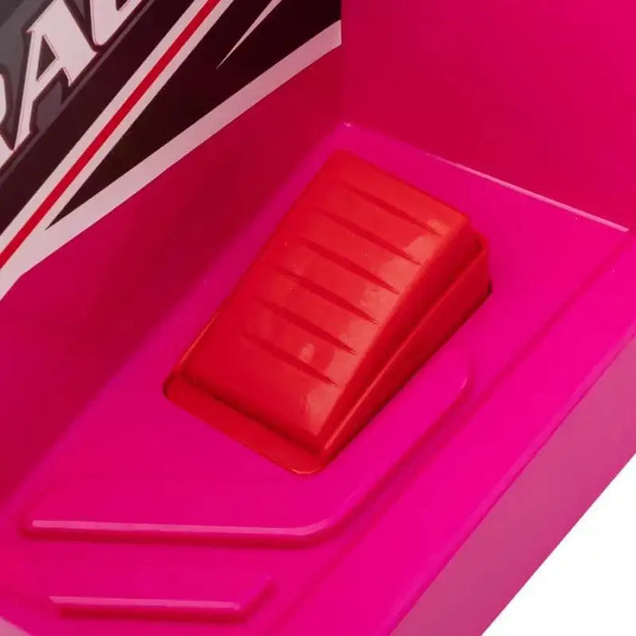 Close-up of red foot pedal on pink kids ride-on quad bike with black and white decal