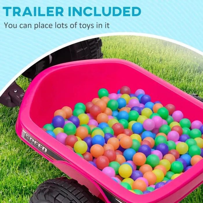 Pink kids ride-on quad bike trailer filled with colorful plastic balls on grass