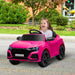 Child driving pink Audi RS Q8 kids electric ride-on car outdoors