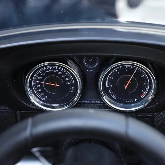 Close-up of BMW 6GT kids ride-on car dashboard with speedometer and gauges