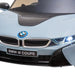 Blue BMW i8 Coupe kids electric ride-on car front view with headlights on
