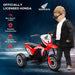 Child in black outfit stands by red Honda kids electric ride-on motorbike with three wheels