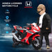 Child in sunglasses stands next to red Honda licensed kids electric ride-on motorbike