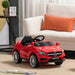 Red Mercedes AMG kids electric ride-on car in living room with cream sofa and orange pillow