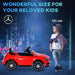 Red Mercedes GLA AMG kids electric ride on car next to child with 121 cm height marker