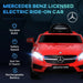 Red Mercedes Benz AMG kids electric ride-on car with headlights on and feature icons