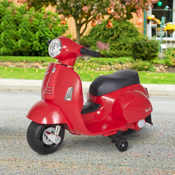Red Vespa kids electric ride-on motorbike with stabilisers on outdoor pavement