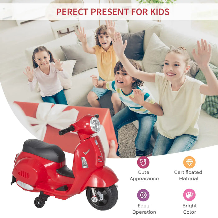 Kids excited on couch with red Vespa electric ride-on motorbike toy and large gift box.