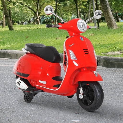 Red kids Vespa electric ride-on motorcycle with LED lights and training wheels outdoors