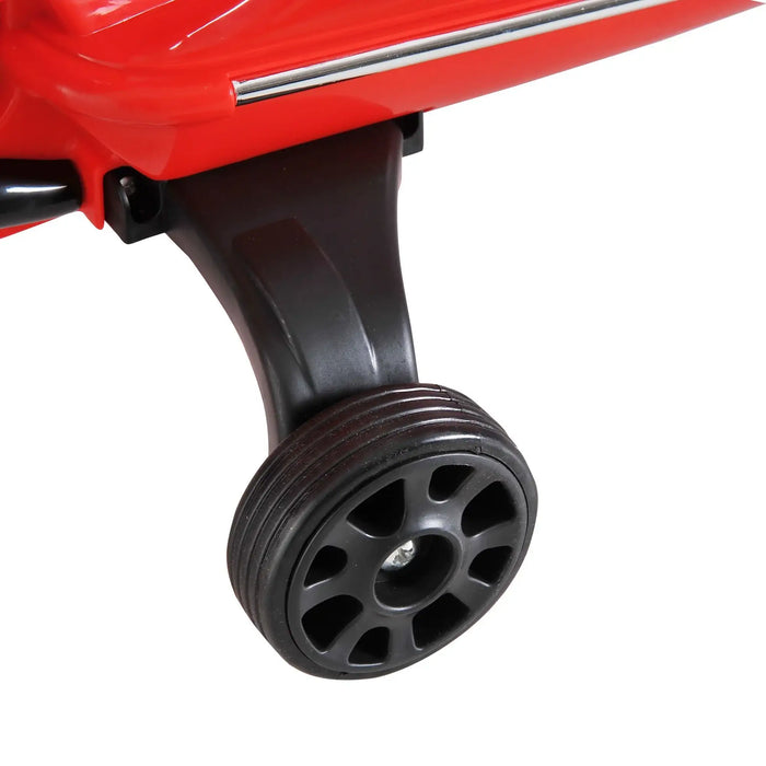 Close-up of black training wheel on red Vespa kids electric ride-on motorcycle