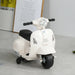 White Vespa kids electric ride-on motorcycle with training wheels indoors