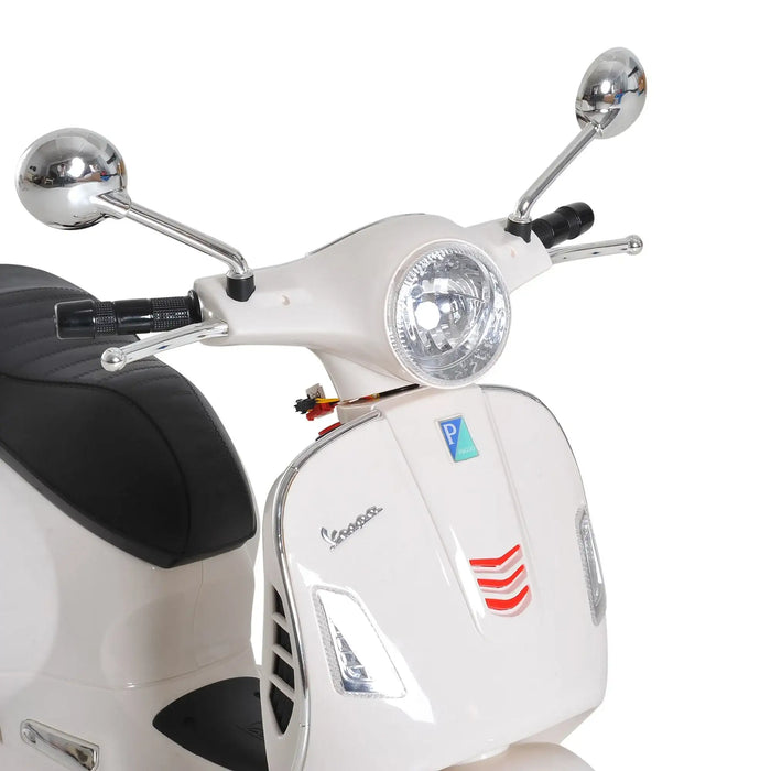 Close-up of white Vespa scooter front with round headlight, chrome mirrors, and black leather seat