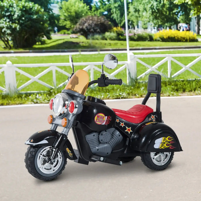 Black retro-style kids electric ride-on motorbike with three wheels and flame decals outdoors