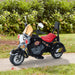 Black retro-style kids electric ride-on motorbike with three wheels and red seat outdoors