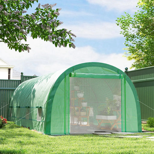 Large green walk-in polytunnel greenhouse with reinforced steel frame in backyard garden